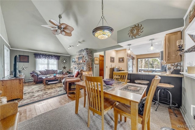 dining space featuring ceiling fan, high vaulted ceiling, a healthy amount of sunlight, and light wood-type flooring