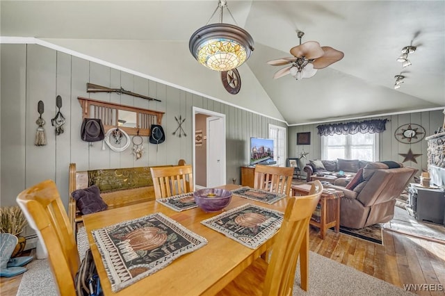 dining room featuring ceiling fan, high vaulted ceiling, and light hardwood / wood-style flooring