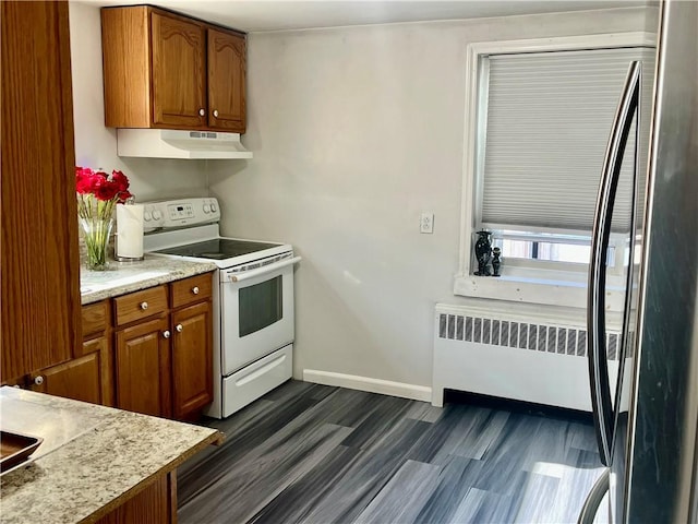 kitchen featuring radiator, electric range, and dark hardwood / wood-style floors