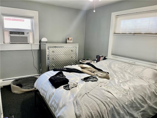 bedroom with cooling unit and a baseboard heating unit