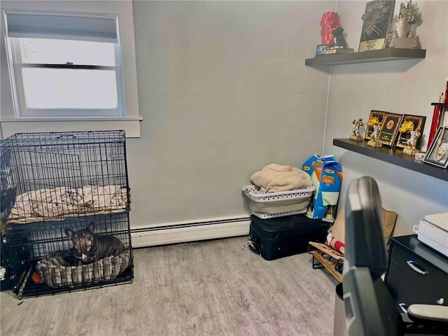 interior space with hardwood / wood-style floors and a baseboard heating unit