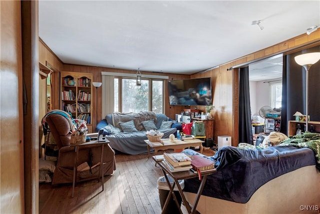 living room featuring hardwood / wood-style flooring and wooden walls