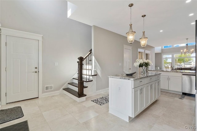 kitchen featuring dishwasher, a center island, light stone counters, white cabinets, and decorative light fixtures