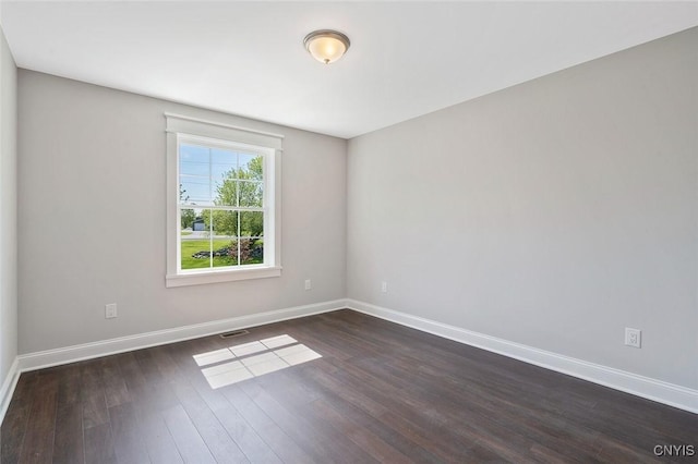 unfurnished room featuring dark wood-type flooring