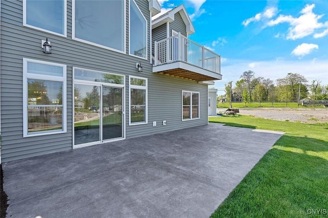 exterior space featuring a yard, a patio area, and a balcony