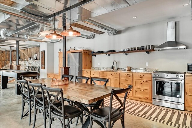 interior space with light brown cabinets, open shelves, a sink, stainless steel appliances, and wall chimney exhaust hood