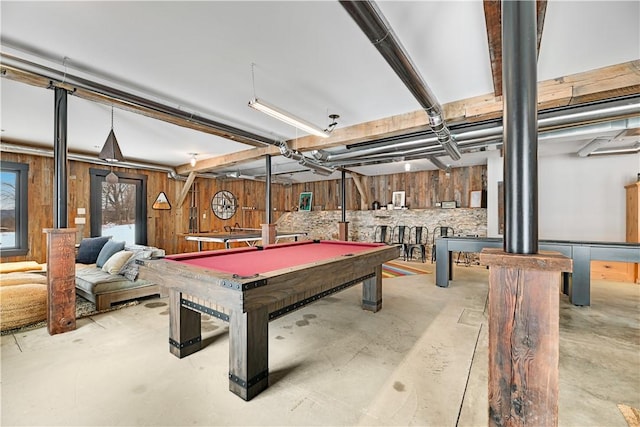 playroom with wooden walls, concrete floors, and billiards