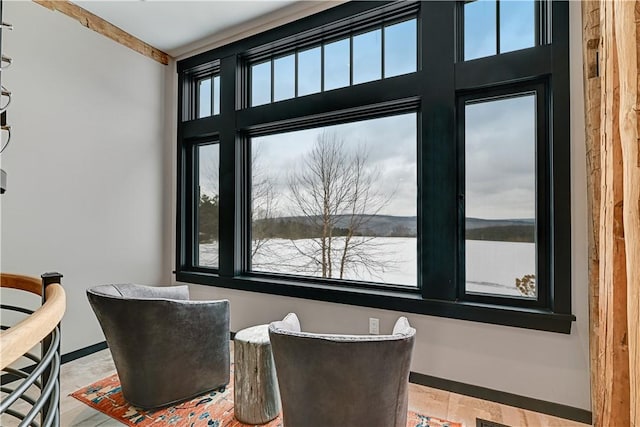 dining room with baseboards, a water view, and a wealth of natural light