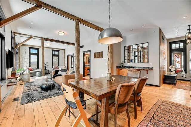 dining room featuring beam ceiling, recessed lighting, light wood-style floors, and baseboards