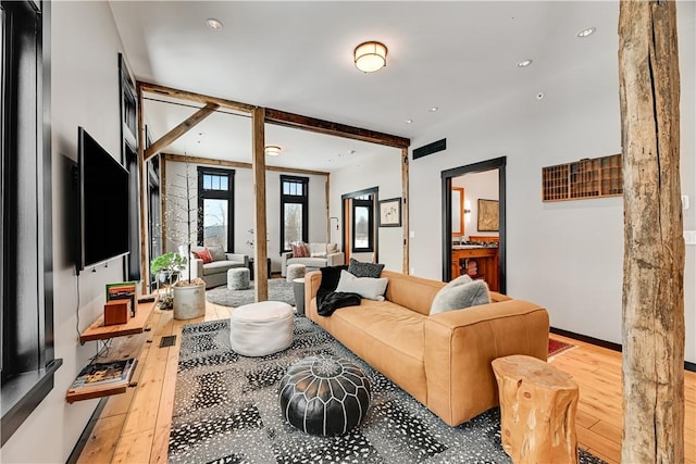 living area with beamed ceiling, recessed lighting, and wood-type flooring