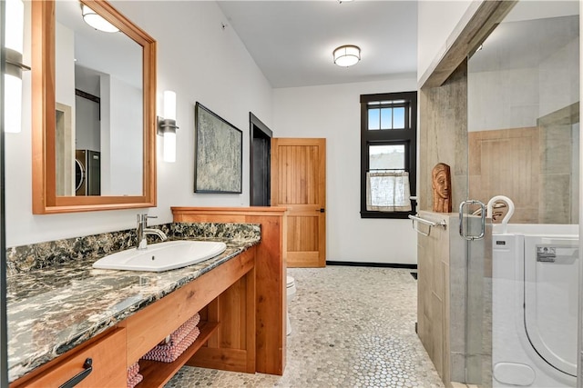 full bath with vanity, toilet, and a shower with shower door