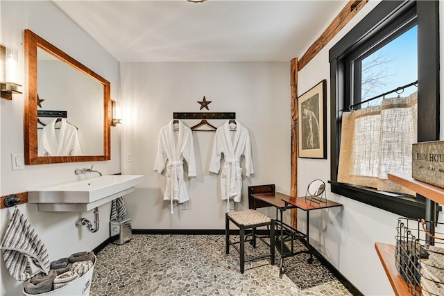 bathroom with baseboards and a sink