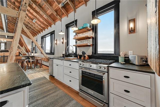 kitchen featuring dark countertops, white cabinets, and stainless steel appliances