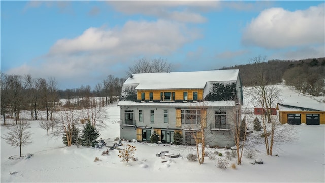 view of snow covered rear of property