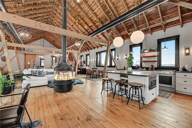 interior space featuring light wood-style floors, a notable chandelier, and dark countertops