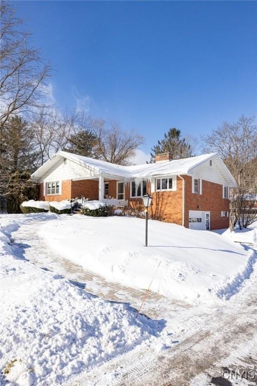 view of snow covered back of property