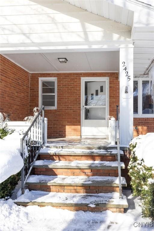 view of snow covered property entrance