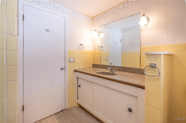 bathroom with vanity, wood-type flooring, and tile walls