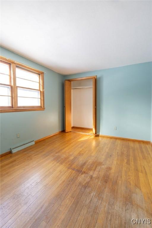 spare room featuring light hardwood / wood-style floors and baseboard heating