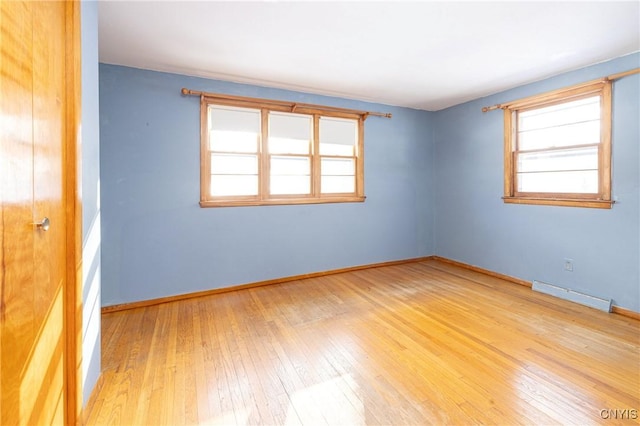 unfurnished room with light hardwood / wood-style floors