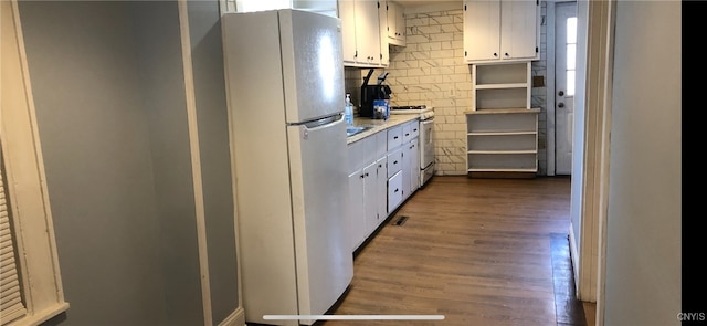 kitchen with white cabinetry, white appliances, and dark hardwood / wood-style flooring