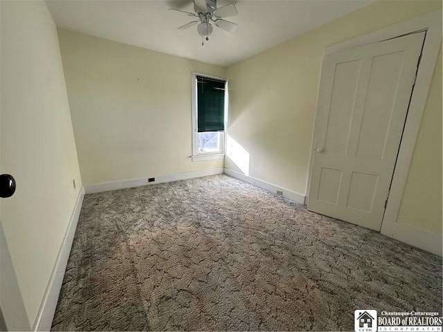 carpeted empty room featuring ceiling fan