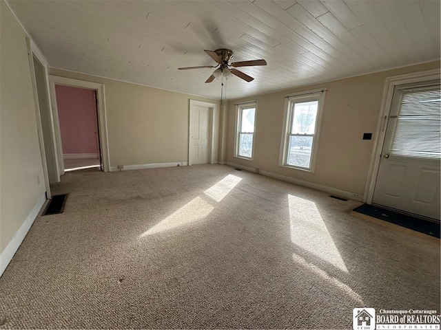 empty room with ceiling fan and carpet