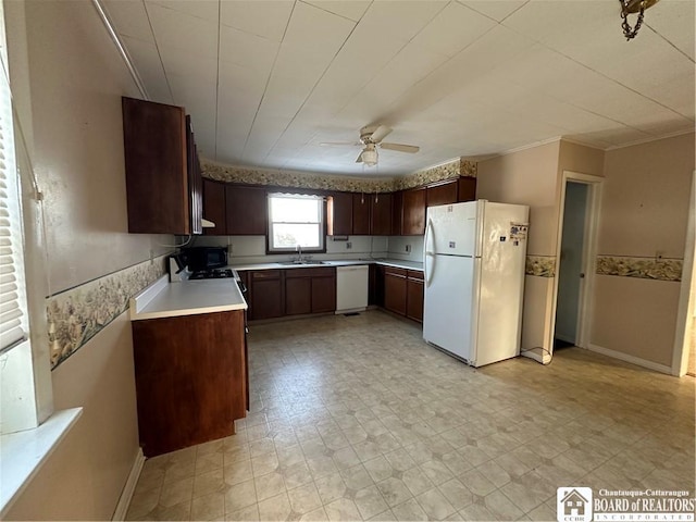 kitchen with ceiling fan, white appliances, dark brown cabinetry, and sink