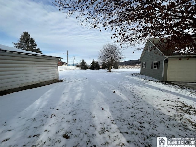 view of yard layered in snow