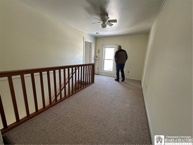 interior space with crown molding, ceiling fan, and carpet floors