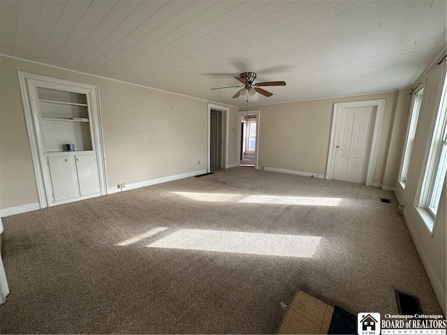 carpeted spare room with wood ceiling and ceiling fan