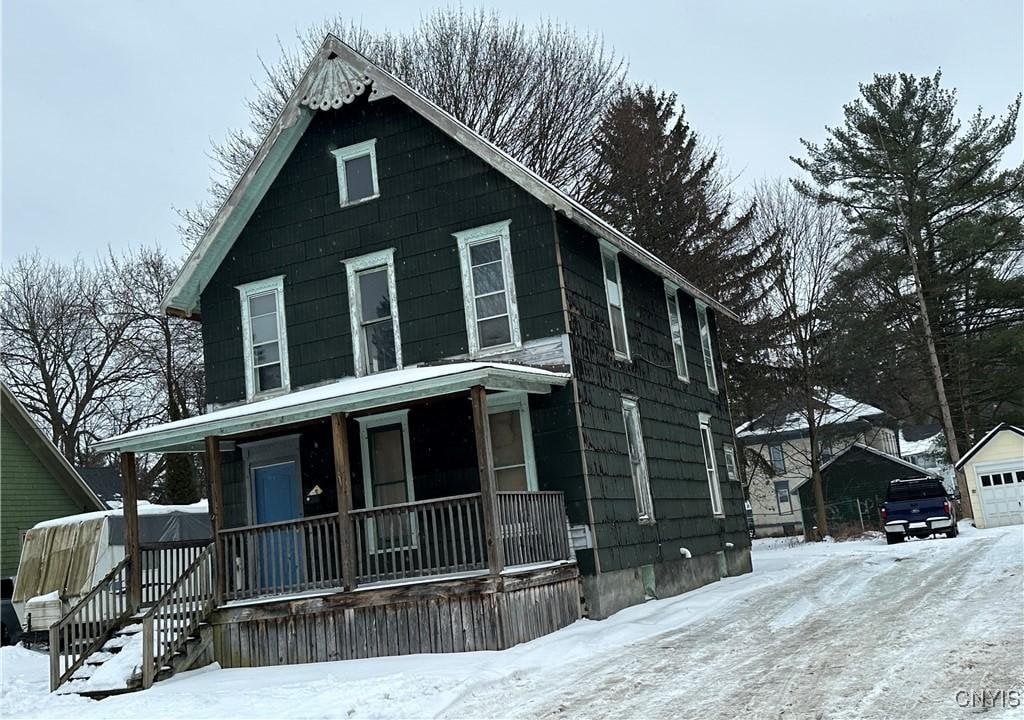 view of front of property with a garage and covered porch