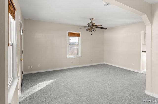 empty room with light colored carpet and ceiling fan