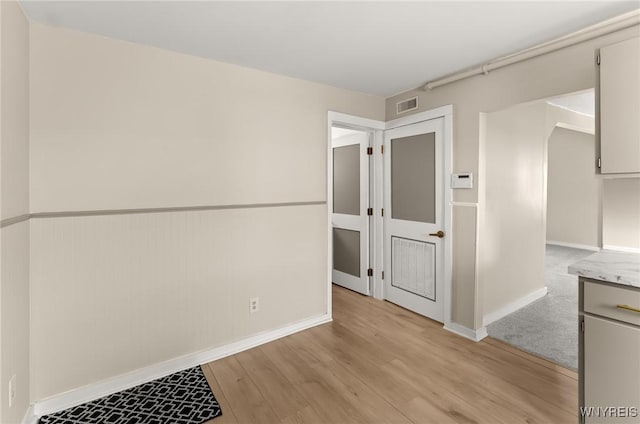 spare room featuring light wood-type flooring