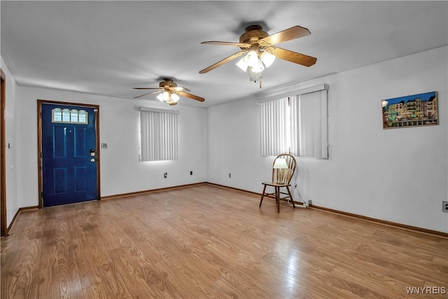 foyer featuring light hardwood / wood-style flooring, ceiling fan, and plenty of natural light