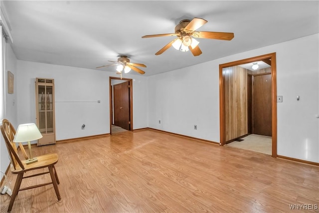 empty room featuring ceiling fan and light wood-type flooring