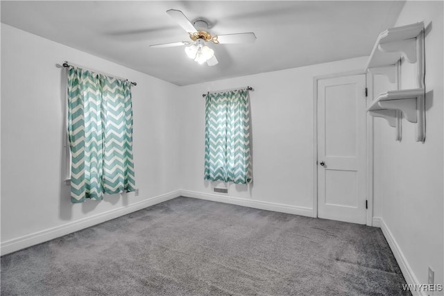 spare room featuring carpet floors and ceiling fan