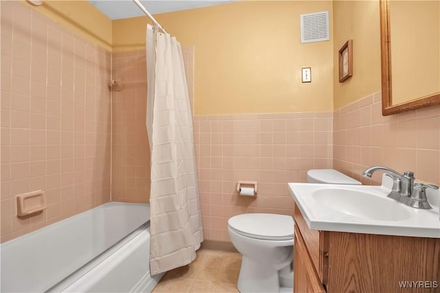 full bathroom with tile patterned flooring, vanity, tile walls, and shower / bath combo