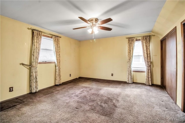 carpeted empty room featuring ceiling fan and vaulted ceiling