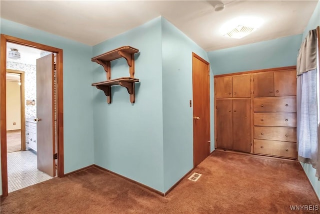 hallway with light colored carpet