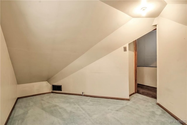 additional living space featuring lofted ceiling and carpet floors