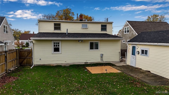 rear view of property with a yard