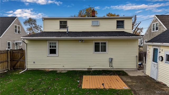 rear view of house featuring a yard