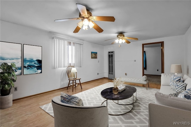 living room with ceiling fan and light wood-type flooring