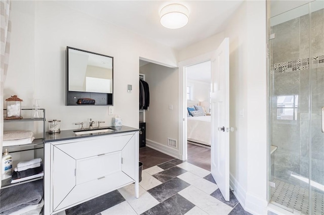 bathroom with walk in shower and vanity