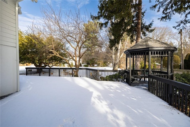 snowy yard featuring a gazebo