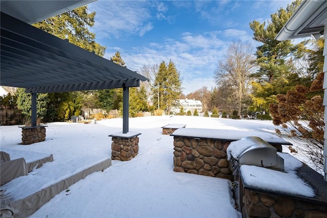 snowy yard featuring a pergola