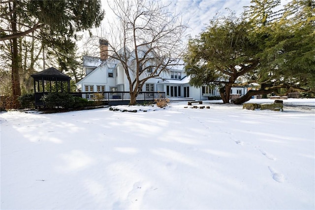 snowy yard with a gazebo