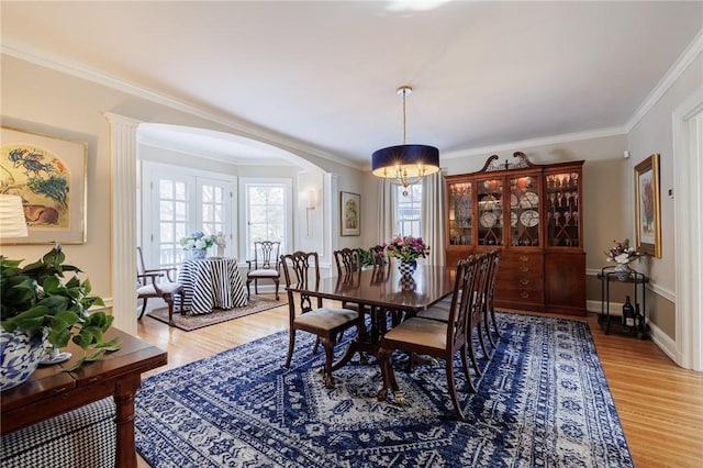 dining area featuring hardwood / wood-style flooring and crown molding