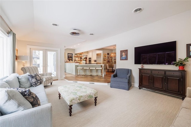 living room with light colored carpet and french doors